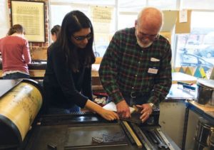 two PALETTE participants work together in letterpress studio