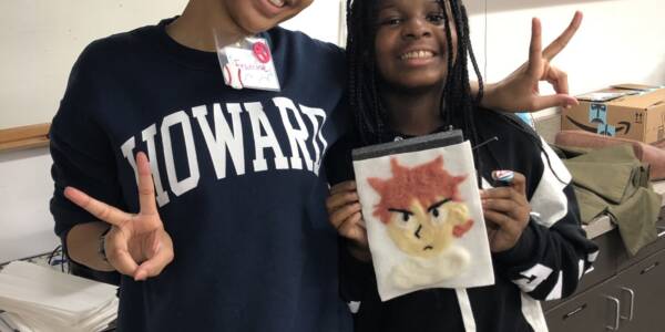 "big" and "little" mentor and mentee stand side by side for during VisArts Make Space program