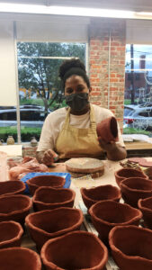 Kourtenay Plummer pictured making clay bowls for VisArts Chili Throwdown